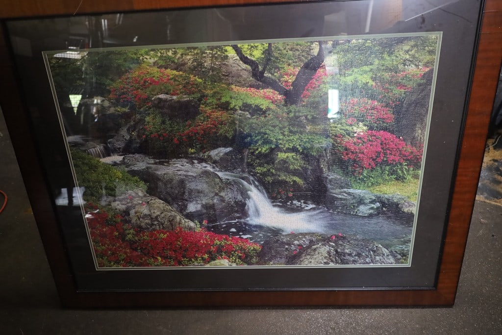FRAMED PUZZLE: A FRAMED PUZZLE OF A CREEK IN THE WOODS. VERY GOOD CONDITION. 38X50