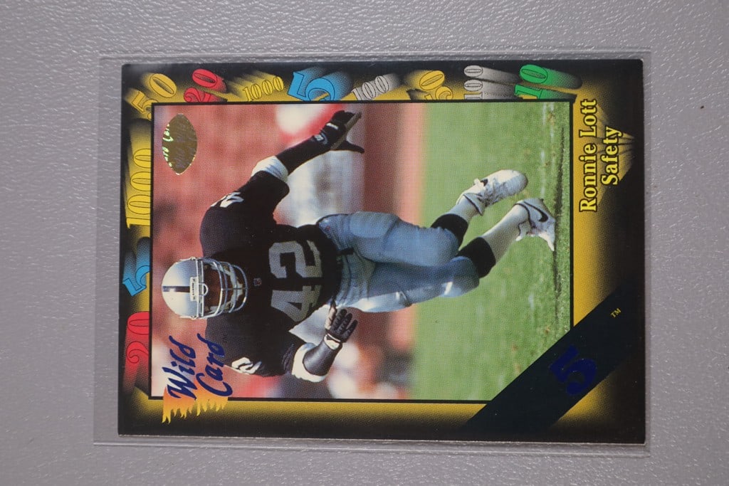 RONNIE LOTT CARD: A 1991 WILD CARD 5 STRIPLE PARALLEL CARD. NEAR MINT OR BETTER CONDITION.