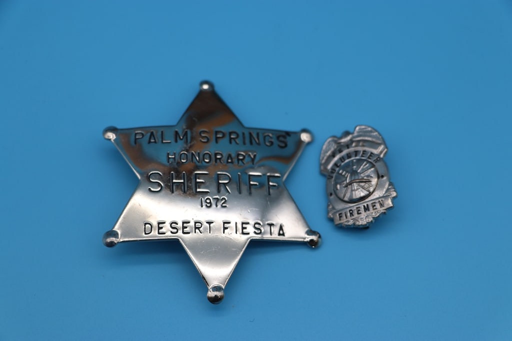 VINTAGE BADGES: A PAIR OF VINTAGE BADGES WITH A 1972 PALM SPRINGS HONORARY SHERIFF BADGE AND FIRE VOLUNTEER. EXCELLENT CONDITION