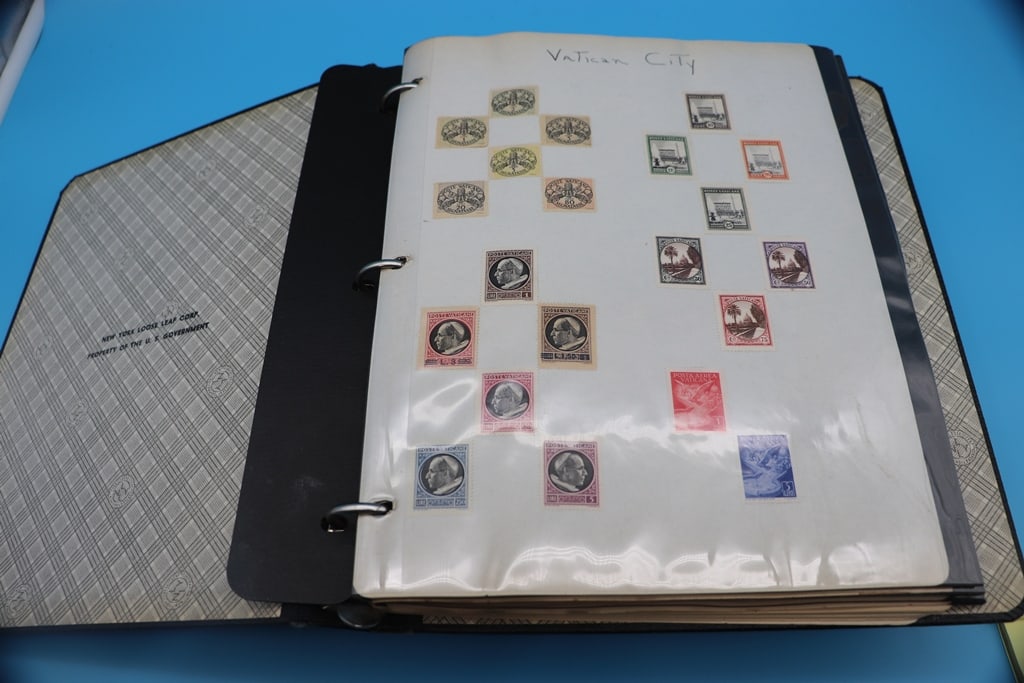 STAMP COLLECTION: A VINTAGE STAMP COLLECTION IN A BOOK WITH STAMPS FROM THE VATICAN. GERMANY AND OTHER PLACES.