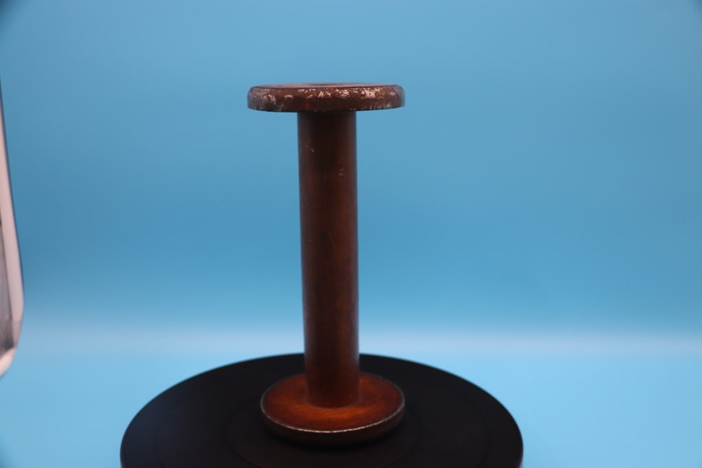 PRIMITIVE SPOOL: AN ANTIQUE PRIMITIVE WOODEN SPOOL. MARKED VERMONT. GOOD CONDITION. 9"