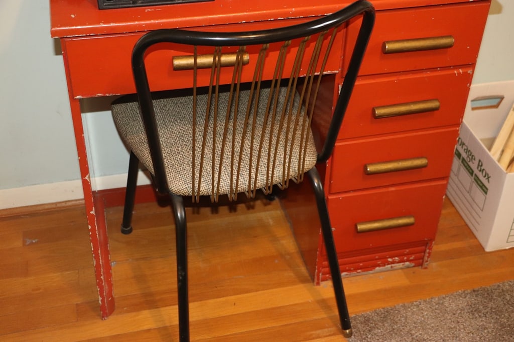 VINTAGE DESK: A VINTAGE DESK AND CHAIR. THERE IS A GUN SAFE MOUNTED TO IT WHICH IS NOT INCLUDED.