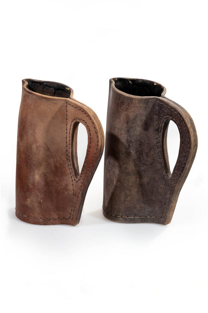 Two leather pitchers from "Pirates of the Caribbean:: This set of two leather pitchers were custom-made for the production. Each stands 11" tall. Comes with a Screen Used COA.