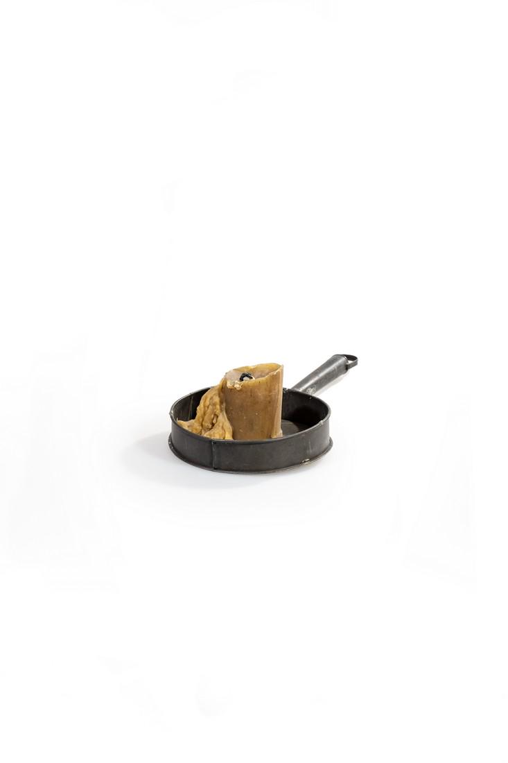 Metal candle holder from "Pirates of the Caribbean:: This metal pan with melted candle was used in the production as set dressing. Comes with a Screen Used COA.