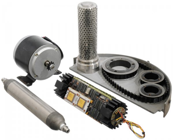 Hero Suit Parts from Cave Workbench: Assorted missile and suit parts seen on Tony's Cave workbench shown while Tony Stark cuts sheet steel for the Mark I power suit. Using various components from Stark Industries weapons Tony builds hims