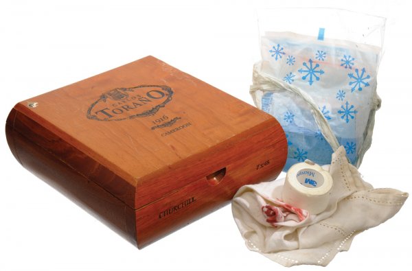 Hero Handkerchief, Cold Pack and Cigar box: Tony Stark tosses this blood stained handkerchief on his desk next to a cigar box. With a cold pack taped to his left shoulder Tony tries to relax on the couch after crashing through the ceiling while