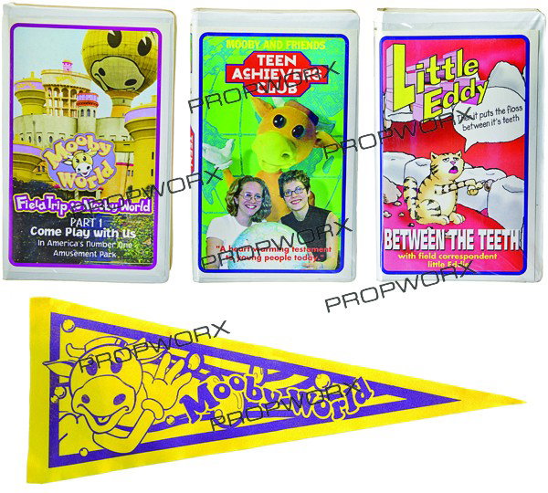 Set of Mooby VHS Cases and Banner: Production Description: A set of three VHS tape cases and banner with Mooby logo's that were used as set decoration in the Mooby corporate boardroom from "Dogma." Production noted the VHS tapes as the