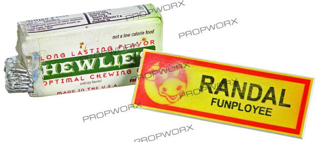 Randal's Hero Name Tag & Chewies Gum: Production Description: The name tag worn by Randal Graves on the front right of his Mooby uniform. Included is the hero pack of "Chewlie's" gum Randal was holding on the drive into work with Dante. T