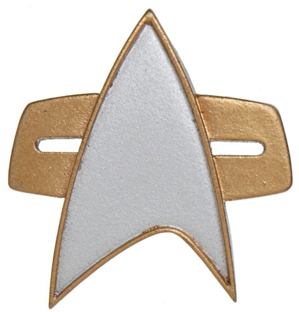 Star Trek: Nemesis Combadge: Production Description: Screen used com badge in the design of the later delta shield. This badge was used in Star Trek: Nemesis and features a small Velcro backing. Technical Description: Resin cast 