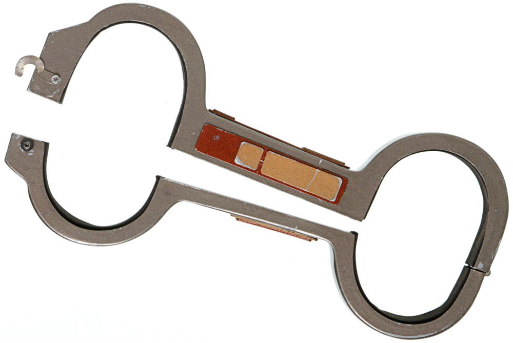 Star Trek: Deep Space Nine Era Handcuffs: Production Description: Futuristic designed Handcuffs used to detain prisoners . This item features a opening and closing top and held together with strong magnets inside and a side latch. This item