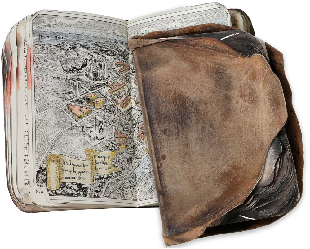 Battlestar Galactica Burnt Book Of Pythia: Production Description: A burnt and bloody copy of the Book of Pythia, which told of the exodus and exile of the Thirteen Tribes from Kobol 3,600 years prior to the Fall of the Twelve Colonies. Pythia