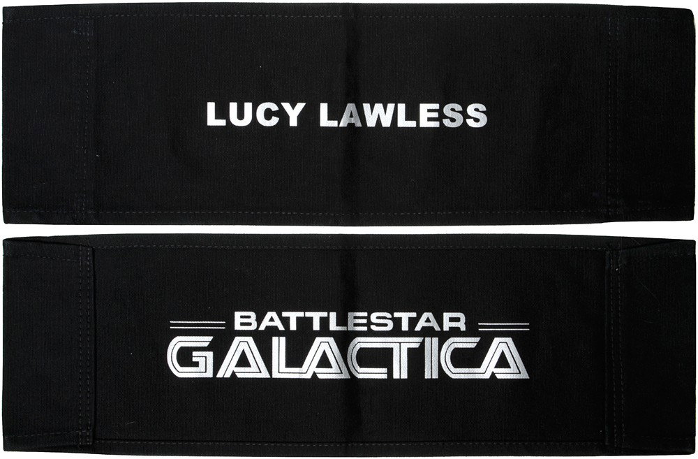 Battlestar Galactica Lucy Lawless Chair Back: Production Description: This black chair back was used on set as a place holder for the actor or actress chair's in-between filming on Battlestar Galactica. Technical Description: Black cotton chair b