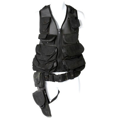 SG Team Black Tactical Vest and Holster: Production Description: Tactical vest and holster of the types worn by members of SG teams on offworld missions. Production did not note exactly which episode or scene this vest was worn in. Technical