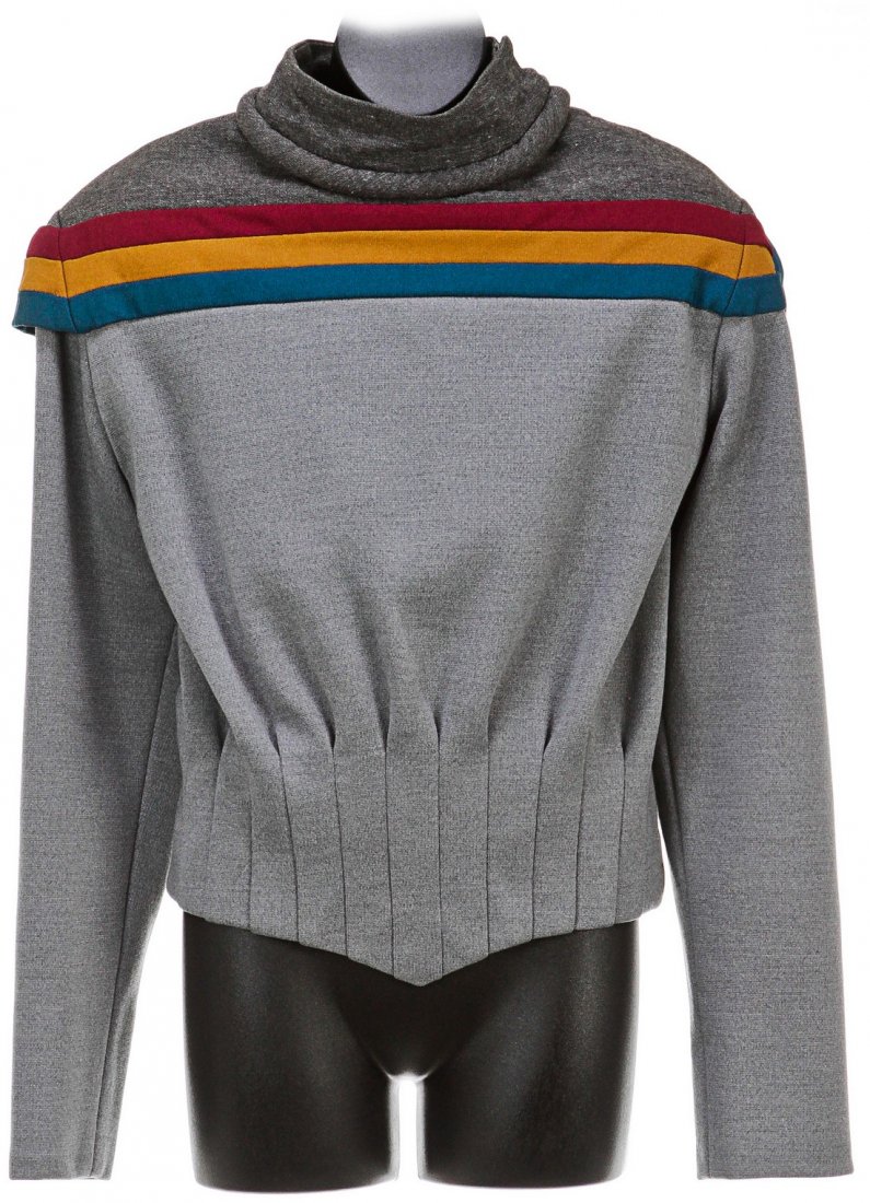 Star Trek: The Next Generation Wesley Crusher Starfleet: A grey sweater with three bands of burgundy, blue and gold across the chest, made to be worn by Wesley Crusher (Will Wheaton) in the first season of Star Trek: The Next Generation. This style of unifo