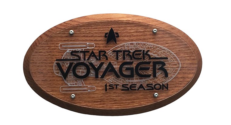Star Trek: Voyager Season One Crew Plaque: First season Star Trek: Voyager plaque given out to members of the cast and crew after filming wrapped. This rare item features the ship Voyager silkscreened on the fornt with the shows logo. Item is 