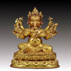 A solemn gilt bronze statue of the God of Wealth with an elephant trunk inlaid with precious stones