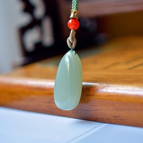 An Exquisite Greenish Jade Pendant