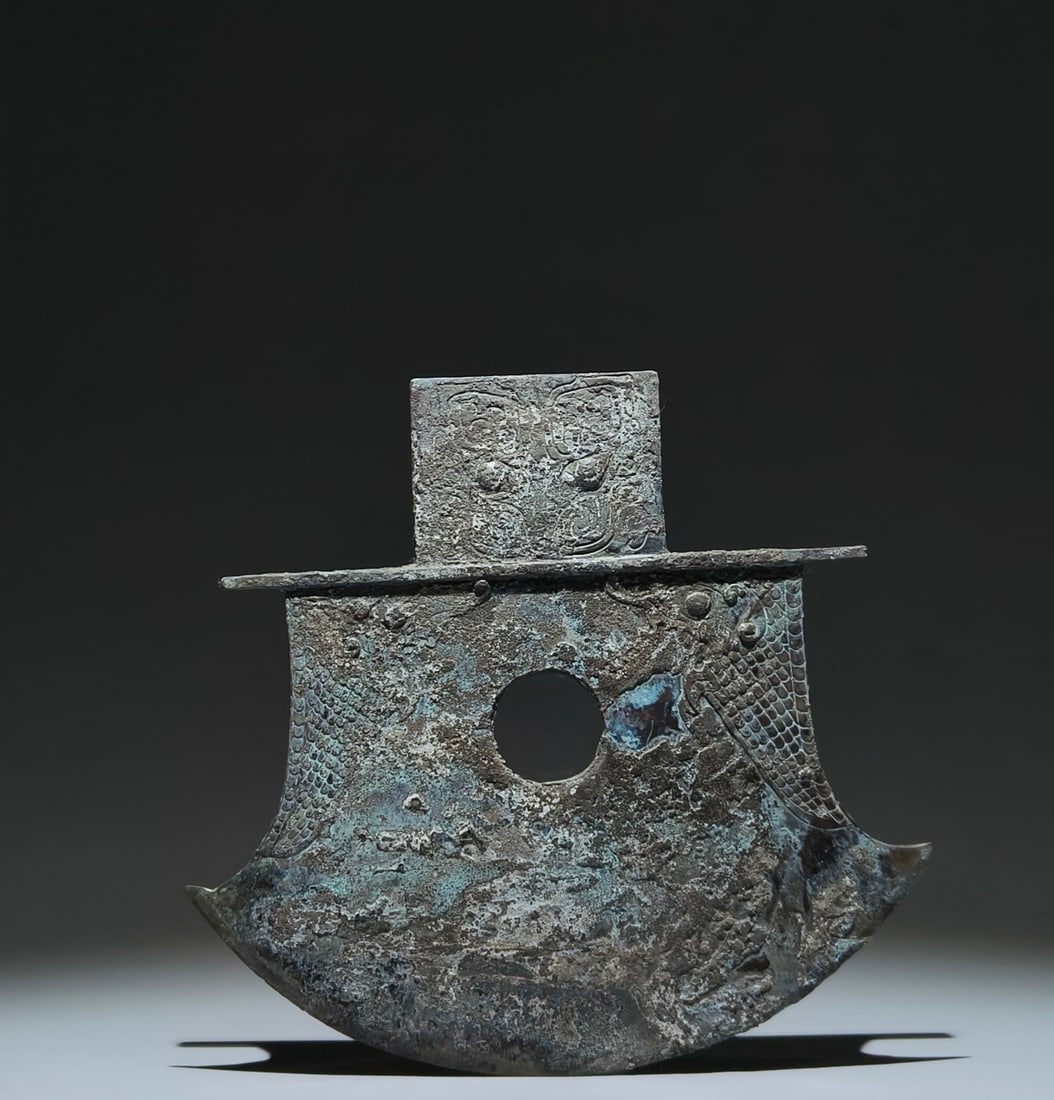 An Archaic Bronze Beast-Face and Fish Pattern Weapon: An Archaic Bronze Beast-Face and Fish Pattern Weapon,Shang Dynasty, China,Size:9.3inx8.7in 青铜兽面鱼纹兵器,中国商代