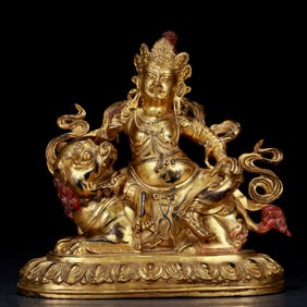 An exquisite gilt bronze statue of Mammon riding a lion