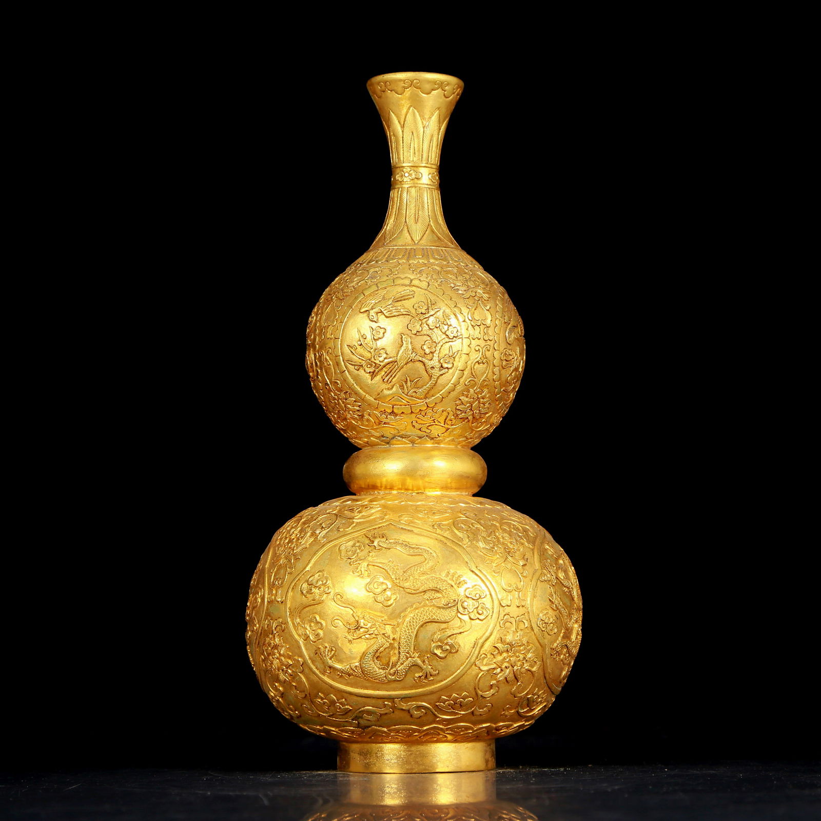An exquisite gilt bronze gourd vase with flower and bird patterns: An exquisite gilt bronze gourd vase with flower and bird patterns, Qing Dynasty, China. The surface has been carefully carved, vividly demonstrating the superb skills of the craftsman. It has its own