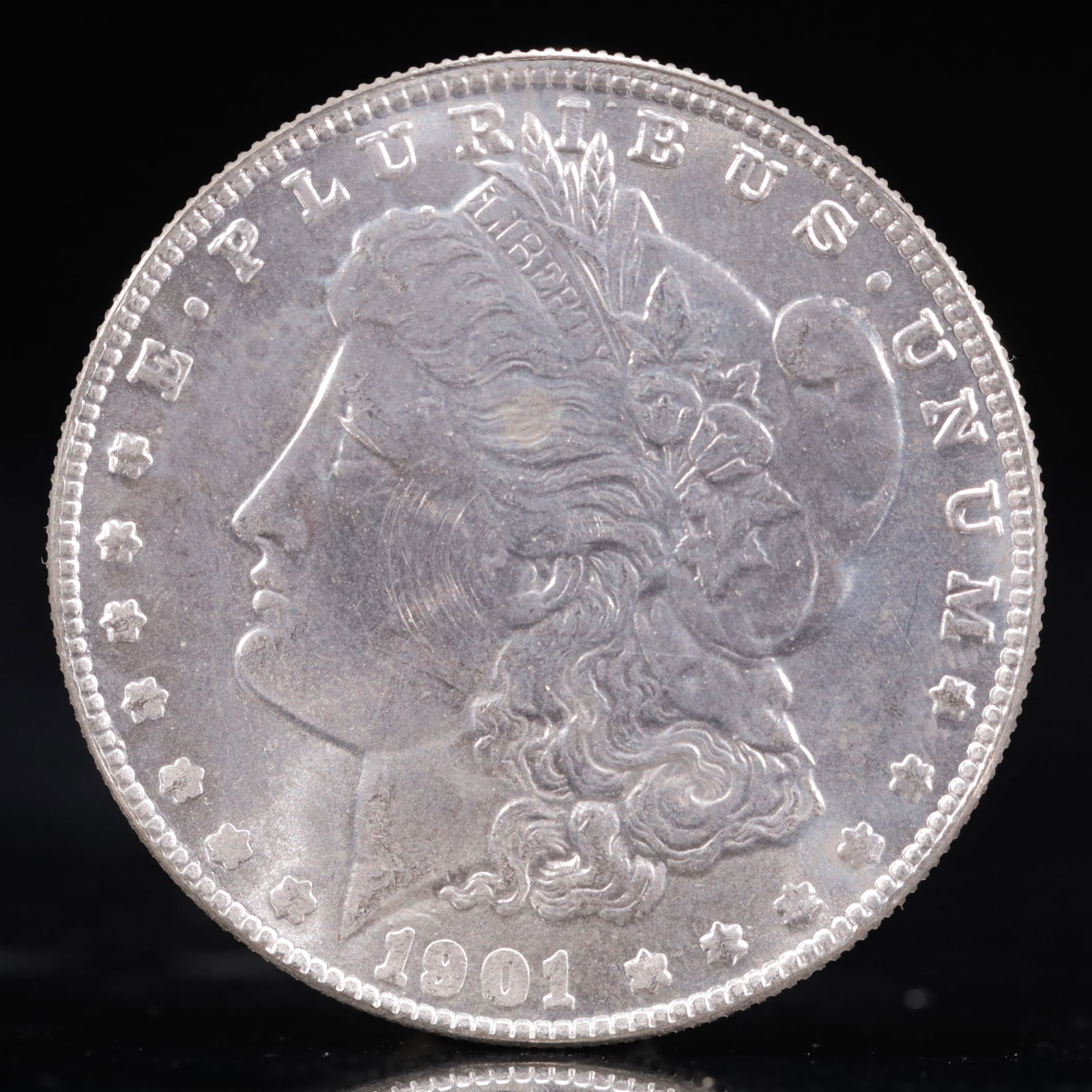 USA Morgan Dollar 1901 Coin: Obv: profile bust with date below and E PLURIBUS UNUM legend and stars around. Rev: eagle with In God we trust above within wreath with UNITED STATES OF AMERICA ONE DOLLAR legend. IN GOD WE TRUST /
