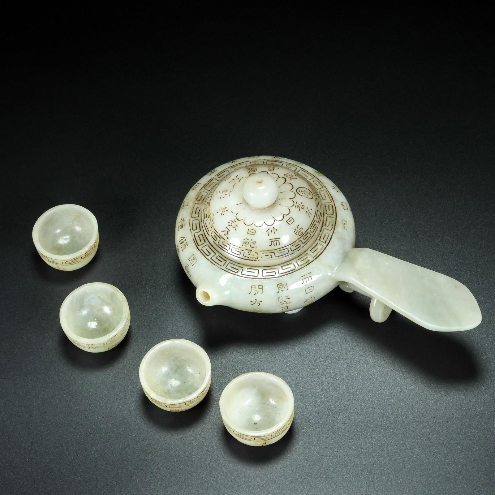 A Set of Fine White Jade Poem Pot,with Four Cups: A Set of Fine White Jade Poem Pot,with Four Cups,Qing Dynasty,China,Qianlong Four-Character Mark,Size:(Pot)3.1inx6.7inx4.3in,(Cup)0.8inx1.4in,Weight:308g 