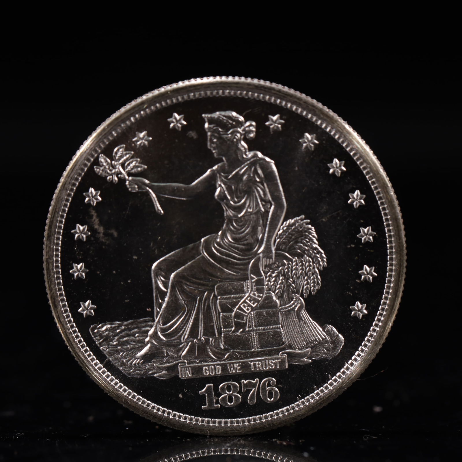 USA Trade Dollar 1876 Coin: American coin. Obverse: Liberty seated on a pedestal facing the sea to the left holding olive branches surrounded by 13 stars. IN GOD WE TRUST / LIBERTY / 1876. Reverse: An eagle holding branches with