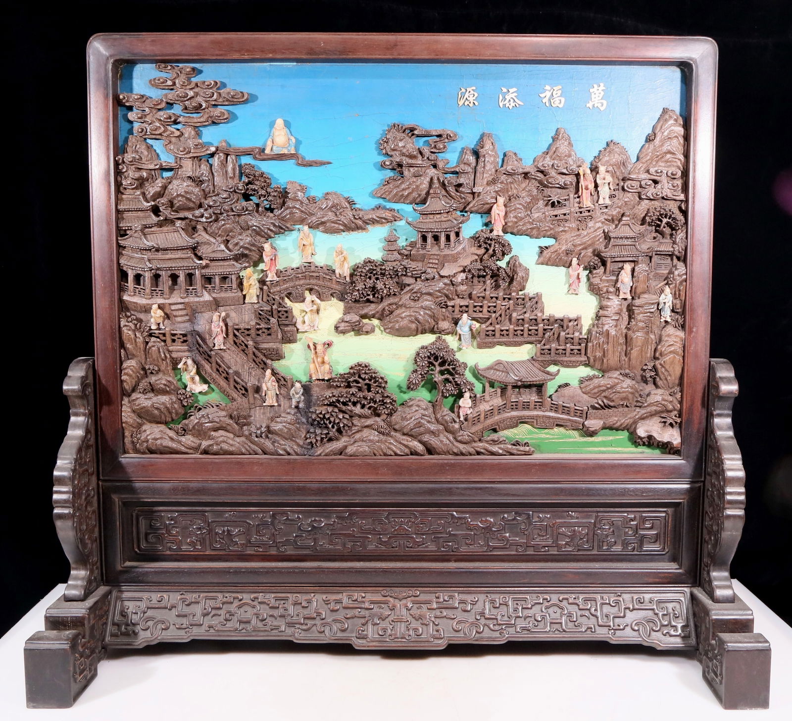An exquisite zitanwood lacquered and gold-embedded table screen with a pattern of immortals: An exquisite zitanwood table screen filled with lacquer, gold-embedded and inlaid with gems, depicting the birthday celebrations of immortals. Qing Dynasty , China. using zitanwood as the base
