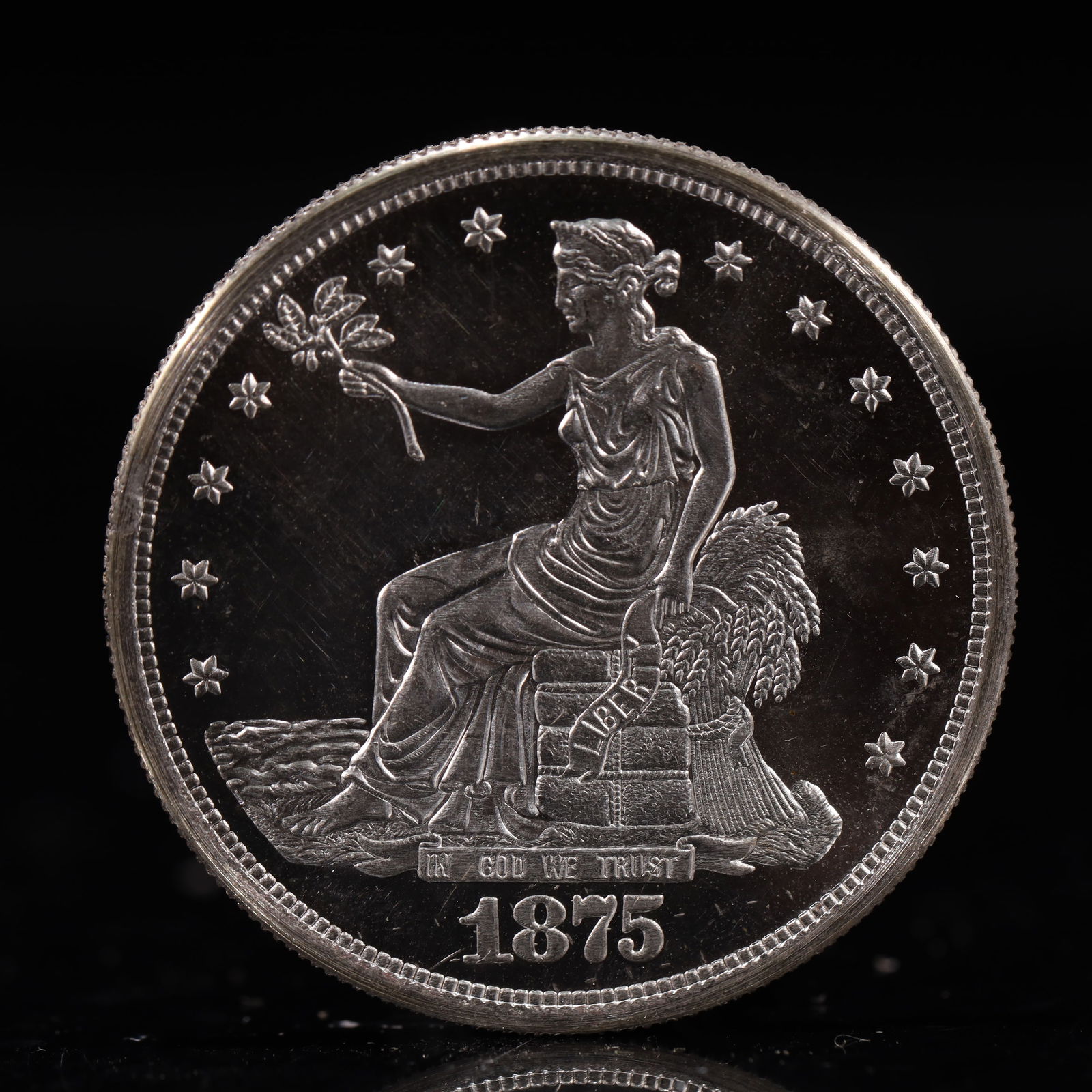 USA Trade Dollar 1875 Coin: American coin. Obverse: Liberty seated on a pedestal facing the sea to the left holding olive branches surrounded by 13 stars. IN GOD WE TRUST / LIBERTY / 1875. Reverse: An eagle holding branches
