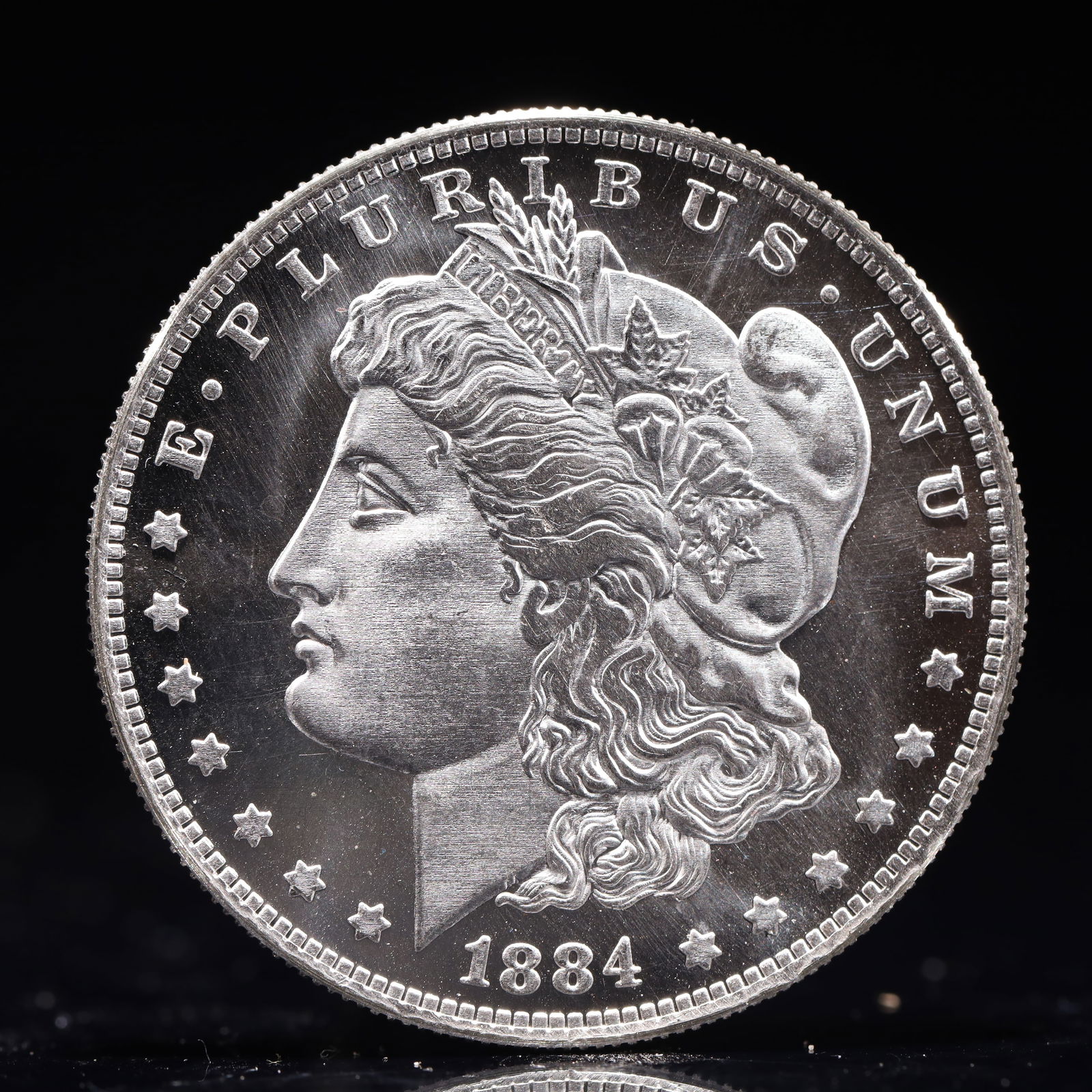 USA Morgan Dollar 1884 Coin: Obv: profile bust with date below and E PLURIBUS UNUM legend and stars around. Rev: eagle with In God we trust above within wreath with UNITED STATES OF AMERICA ONE DOLLAR legend. IN GOD WE TRUST /