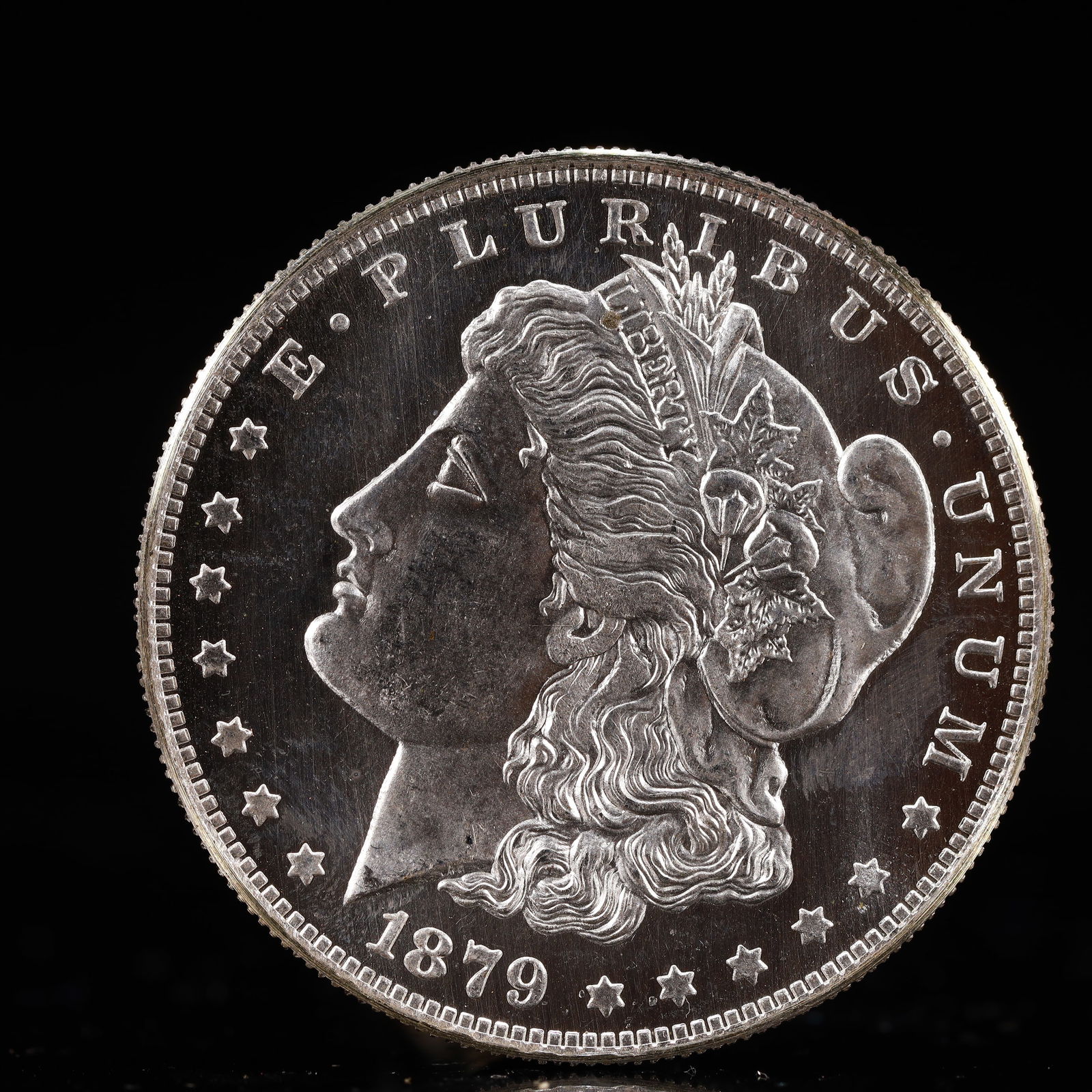 USA Morgan Dollar 1879 Coin: Obv: profile bust with date below and E PLURIBUS UNUM legend and stars around. Rev: eagle with In God we trust above within wreath with UNITED STATES OF AMERICA ONE DOLLAR legend. IN GOD WE TRUST / LI