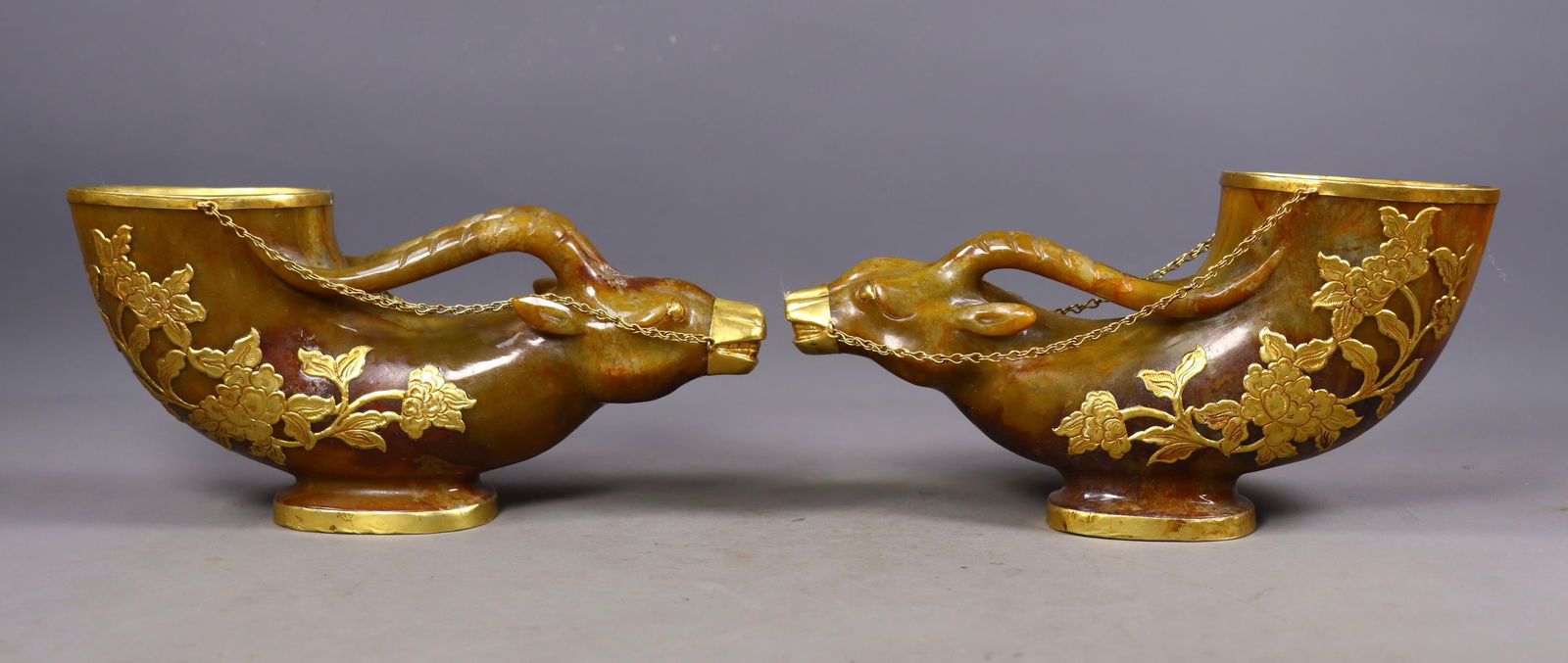 A Pair of Exquisite White Jade Cover with Gold Flower Pattern Buffalo-head Cups: A Pair of Exquisite White Jade Cover with Gold Flower Pattern Buffalo-head Cups,Liao Dynasty, China,Size:4.5inx8.5inx2.8in,Total Weight:2415g 