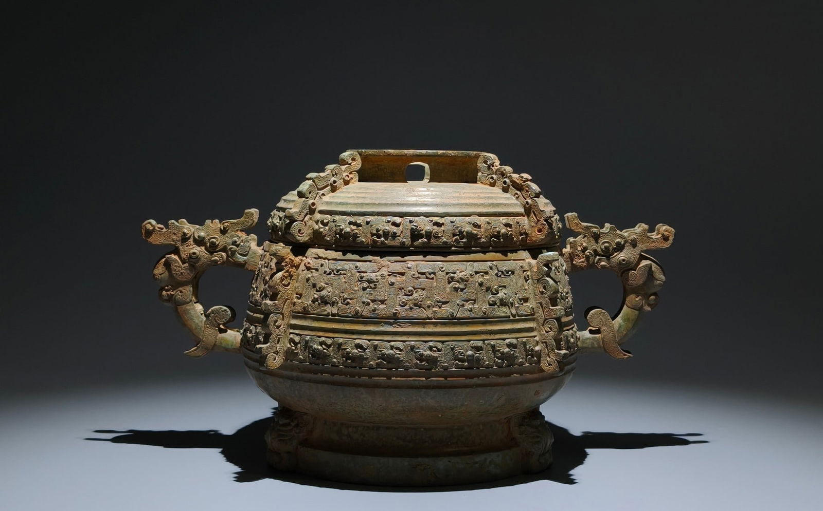 An Archaic Bronze Coiled Chi-Dragon Pattern Beast-Ears Food Vessel,With Inscription: An Archaic Bronze Coiled Chi-Dragon Pattern Beast-Ears Food Vessel,With Inscription,the Spring and Autumn in Period in China,Size:8.7inx14.6inx8.3in 
