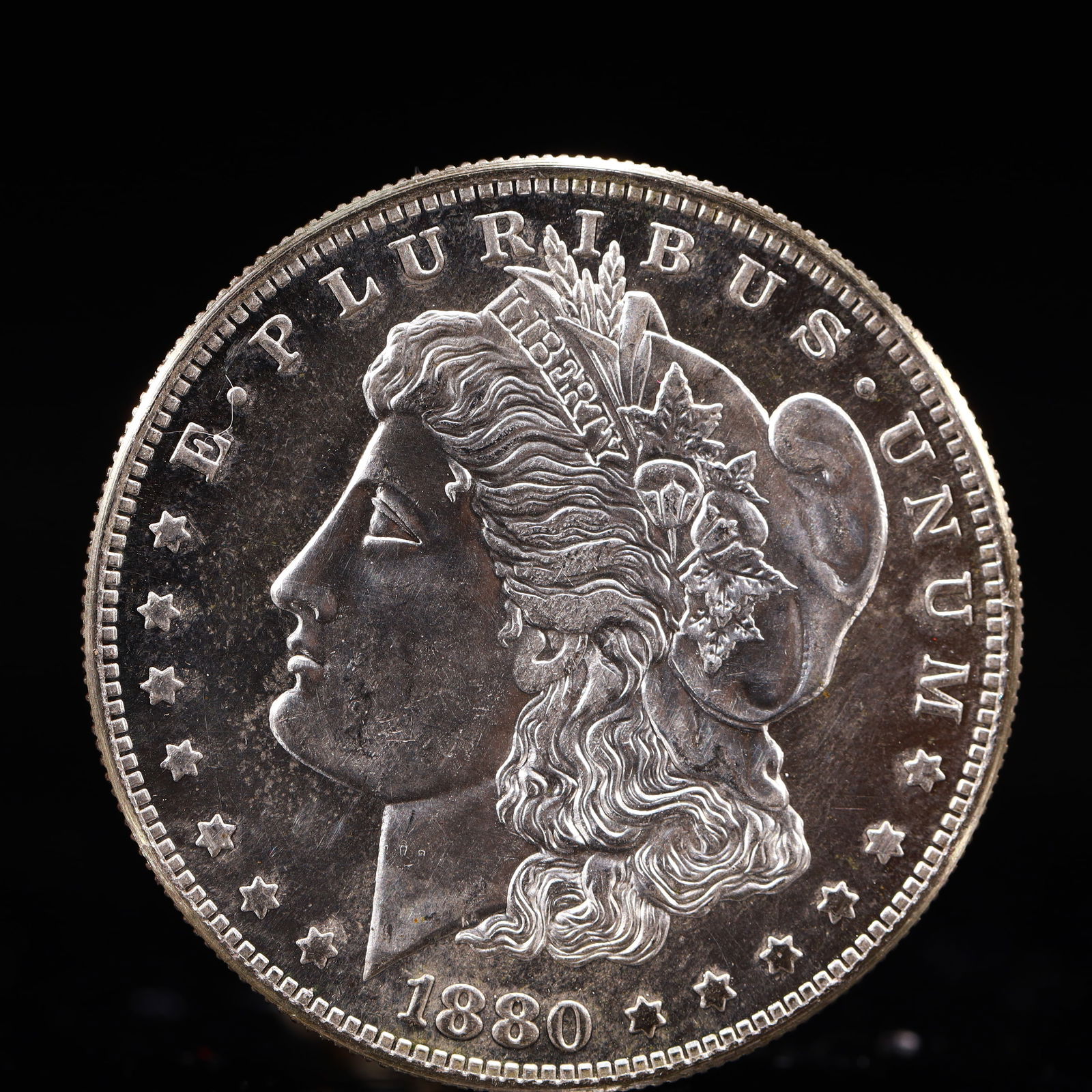 USA Morgan Dollar 1880 Coin: Obv: profile bust with date below and E PLURIBUS UNUM legend and stars around. Rev: eagle with In God we trust above within wreath with UNITED STATES OF AMERICA ONE DOLLAR legend. IN GOD WE TRUST /
