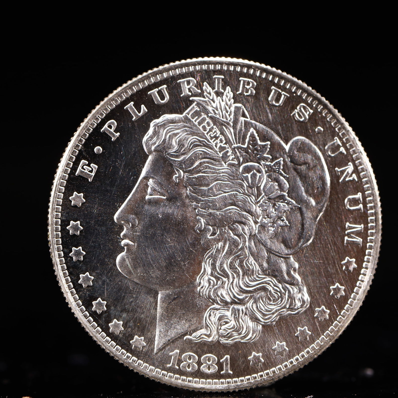 USA Morgan Dollar 1881 Coin: Obv: profile bust with date below and E PLURIBUS UNUM legend and stars around. Rev: eagle with In God we trust above within wreath with UNITED STATES OF AMERICA ONE DOLLAR legend. IN GOD WE TRUST / LI