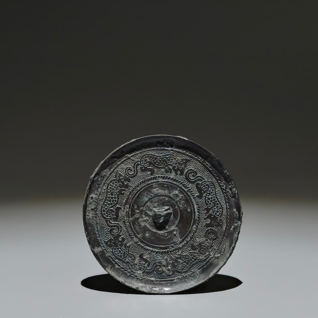 An Archaic Bronze Auspicious Beast Pattern Round Mirror (1 of 9)