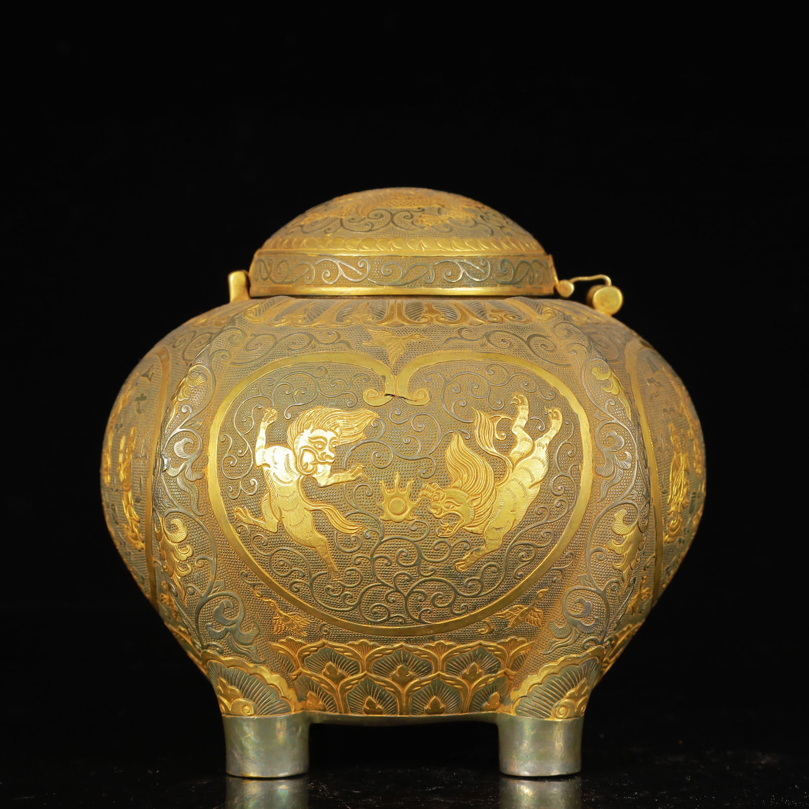 An Exquisite Gilt Silver Figure and Auspicious Beast Pattern Four Legs Cover Jar: An Exquisite Gilt Silver Figure and Auspicious Beast Pattern Four Legs Cover Jar,Tang Dynasty,China,Zhenguan Four-Character Mark,Size:5.5inx4.7inx5.1in,Weight:1000g 