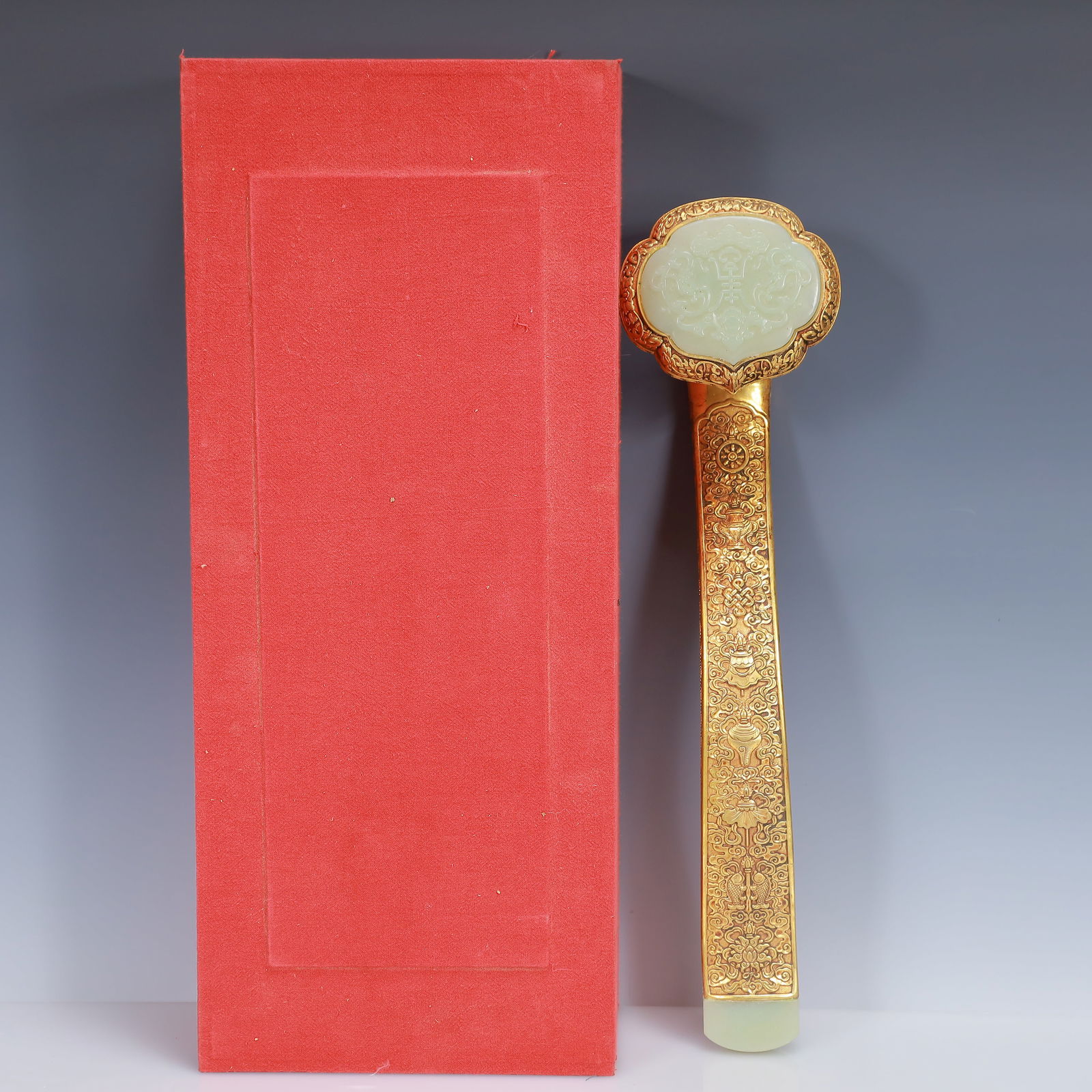 An Exquisite Gilt Bronze Inlaid White Jade Flower Pattern Ruyi Ornament: An Exquisite Gilt Bronze Inlaid White Jade Flower Pattern Ruyi Ornament,Qing Dynasty, China,Size:15inx4.3inx3.1in,(Box)18.5inx7.9inx4.3in,Weight:1300g 