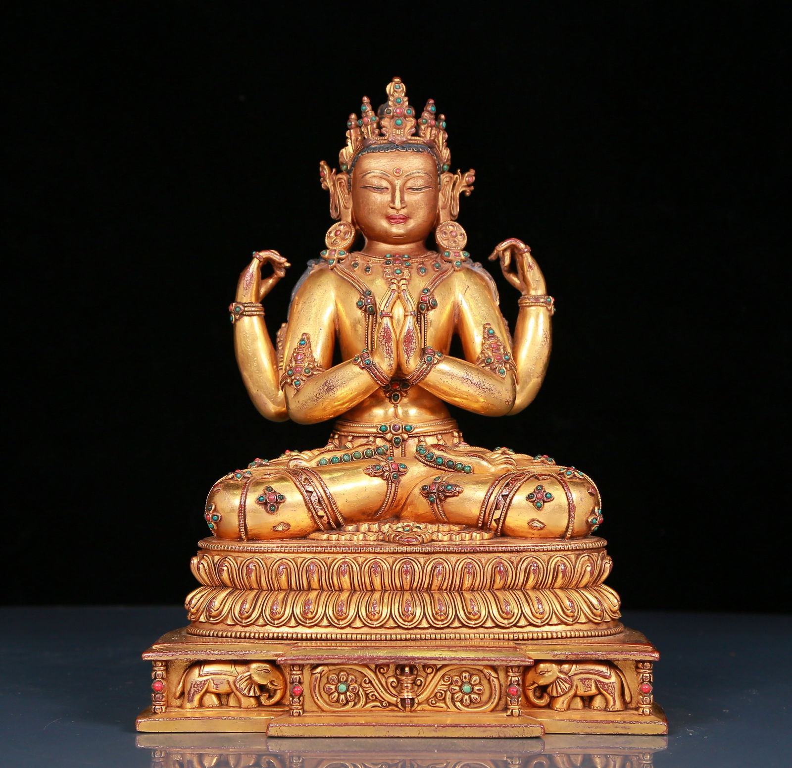 A solemn gilt bronze statue of Guanyin with four arms inlaid with precious stones (1 of 12)