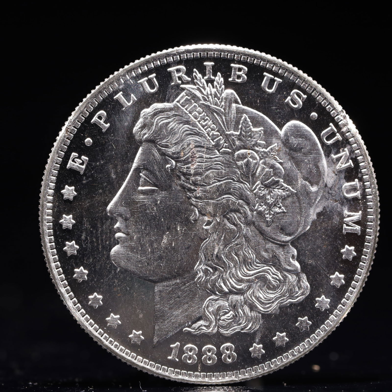 USA Morgan Dollar 1888 Coin: Obv: profile bust with date below and E PLURIBUS UNUM legend and stars around. Rev: eagle with In God we trust above within wreath with UNITED STATES OF AMERICA ONE DOLLAR legend. IN GOD WE TRUST /