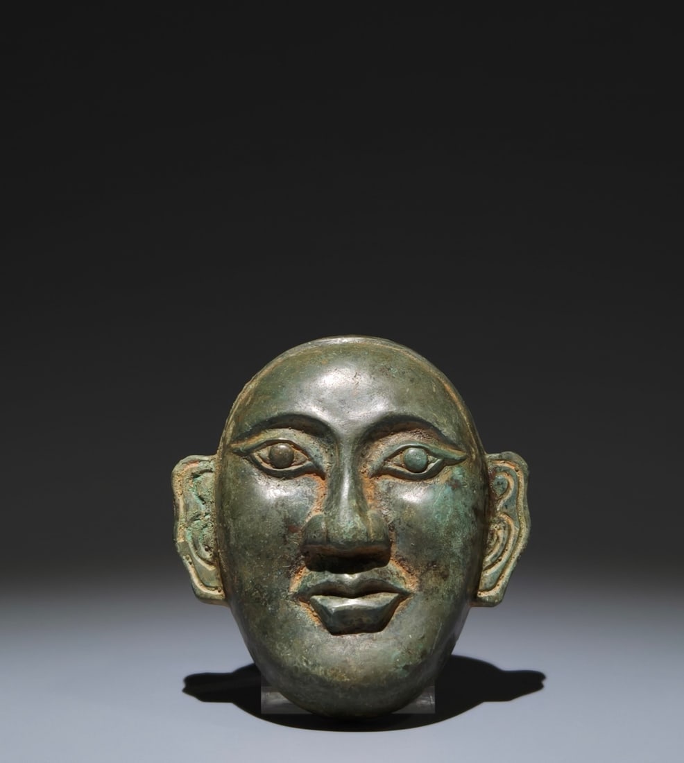 An Archaic Bronze Human-face Pattern Mask (1 of 9)
