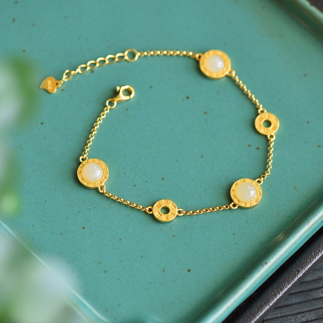 An Exquisite Sterling Silver-Gold Plated Inlaid White Jade Bracelet: An Exquisite Sterling Silver-Gold Plated Inlaid White Jade Bracelet 纯银镀金镶白玉手链