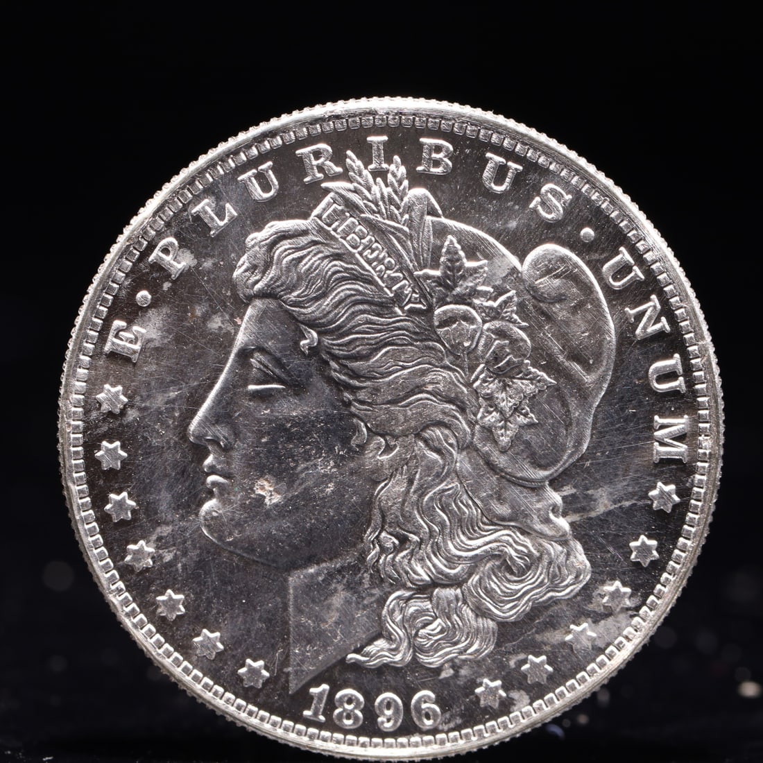 USA Morgan Dollar 1896 Coin: Obv: profile bust with date below and E PLURIBUS UNUM legend and stars around. Rev: eagle with In God we trust above within wreath with UNITED STATES OF AMERICA ONE DOLLAR legend. IN GOD WE TRUST /