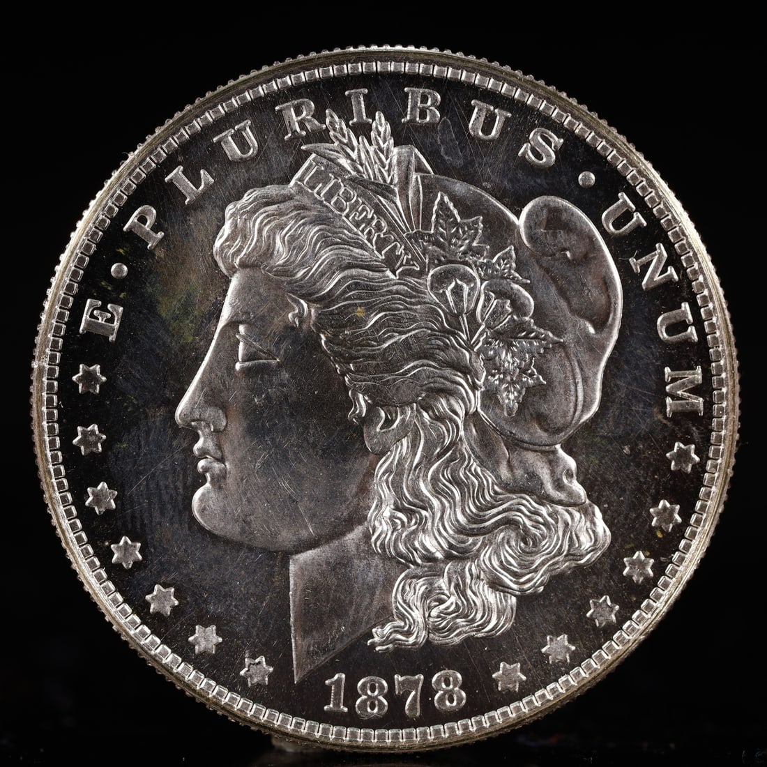 USA Morgan Dollar 1878 Coin: Obv: profile bust with date below and E PLURIBUS UNUM legend and stars around. Rev: eagle with In God we trust above within wreath with UNITED STATES OF AMERICA ONE DOLLAR legend. IN GOD WE TRUST /