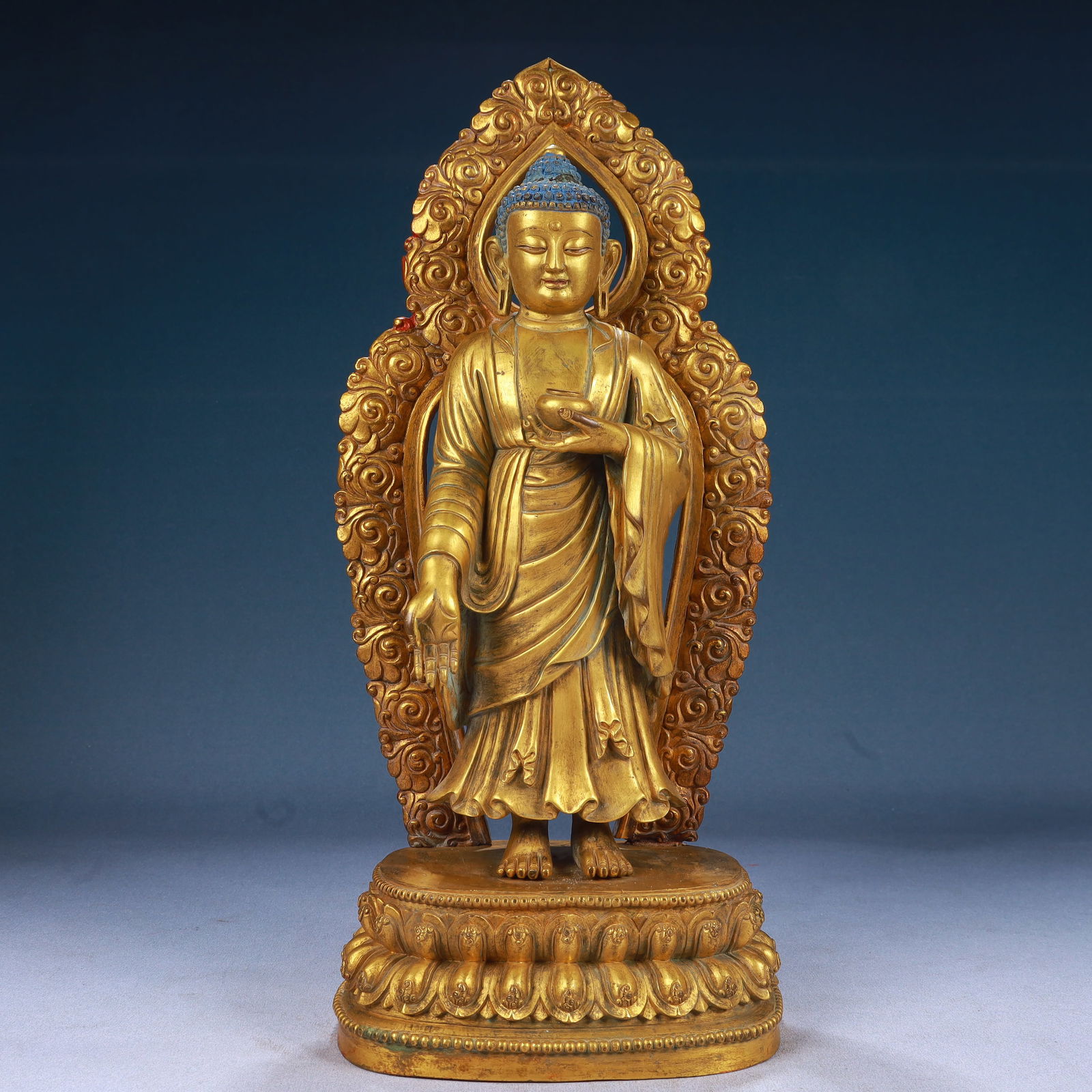A Solemn Gilt Bronze Statue of Sakyamuni: A Solemn Gilt Bronze Statue of Sakyamuni,Ming Dynasty, China,Yongle Six-character Mark,Size:6.7inx4.3inx16.1in,Weight:5100g 铜鎏金如来像,中国明