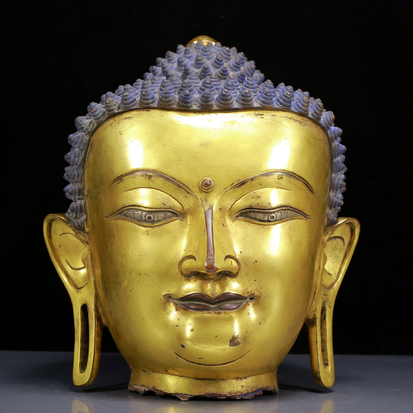 A Solemn Gilt Bronze Sakyamuni Buddha Head: A Solemn Gilt Bronze Sakyamuni Buddha Head,Ming Dynasty, China,Size:11.4inx14.6in,Weight:11245g 铜鎏金释迦摩尼像佛头，明代