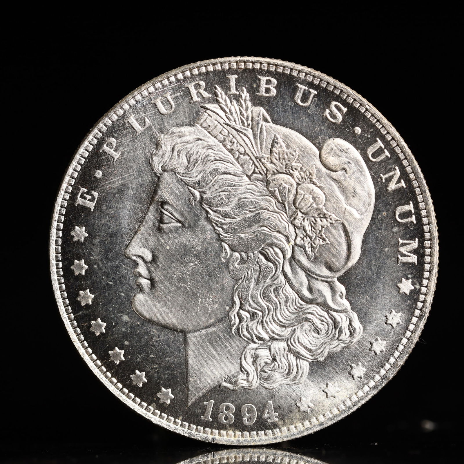 USA Morgan Dollar 1894 Coin: Obv: profile bust with date below and E PLURIBUS UNUM legend and stars around. Rev: eagle with In God we trust above within wreath with UNITED STATES OF AMERICA ONE DOLLAR legend. IN GOD WE TRUST / LI
