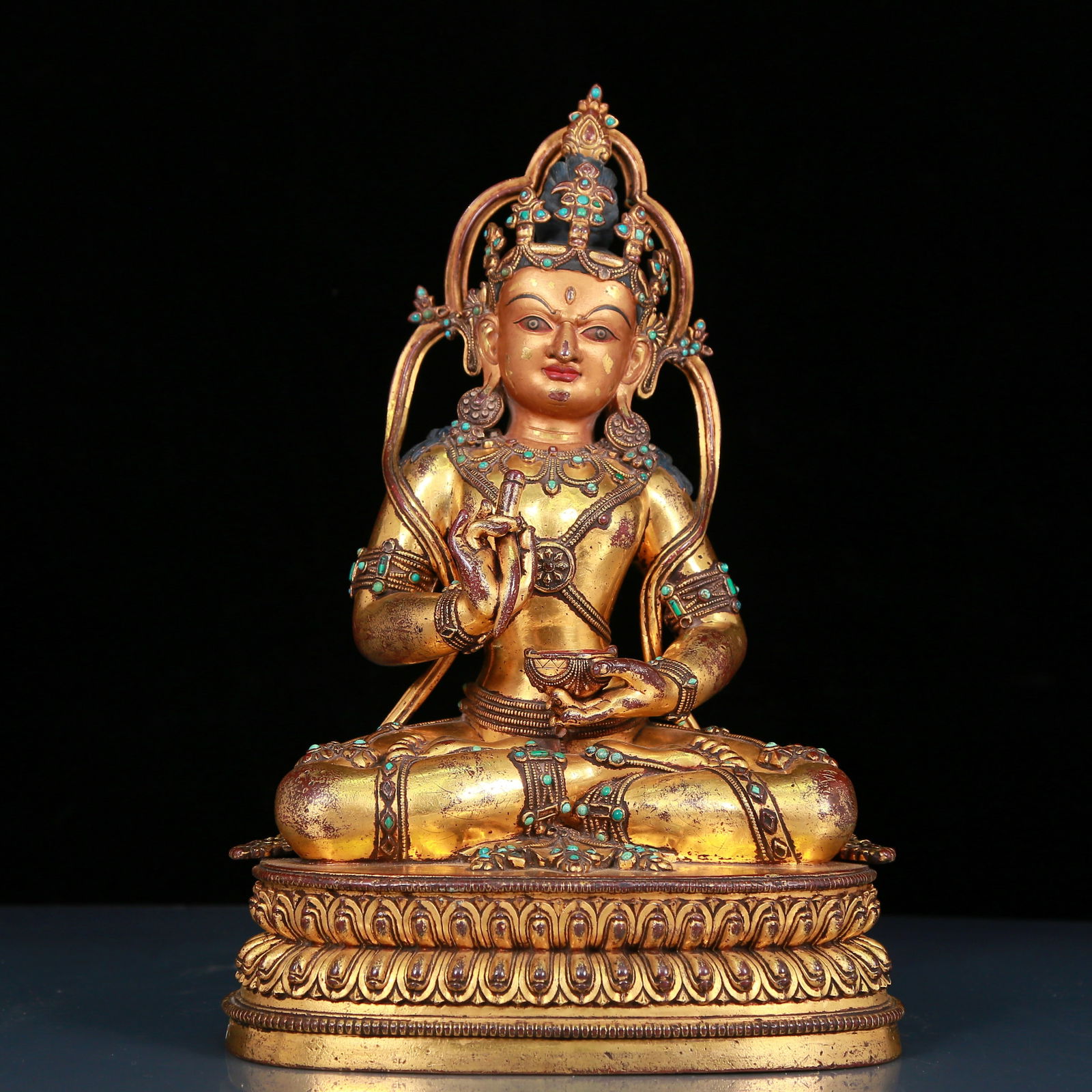 solemn gilt bronze statue of Bodhisattva inlaid with turquoise: A solemn gilt-bronze inlaid turquoise Bodhisattva statue Ming Dynasty, China. The Bodhisattva has a graceful and peaceful posture. His face is solemn and kind, and his eyes are deep, as if he can see