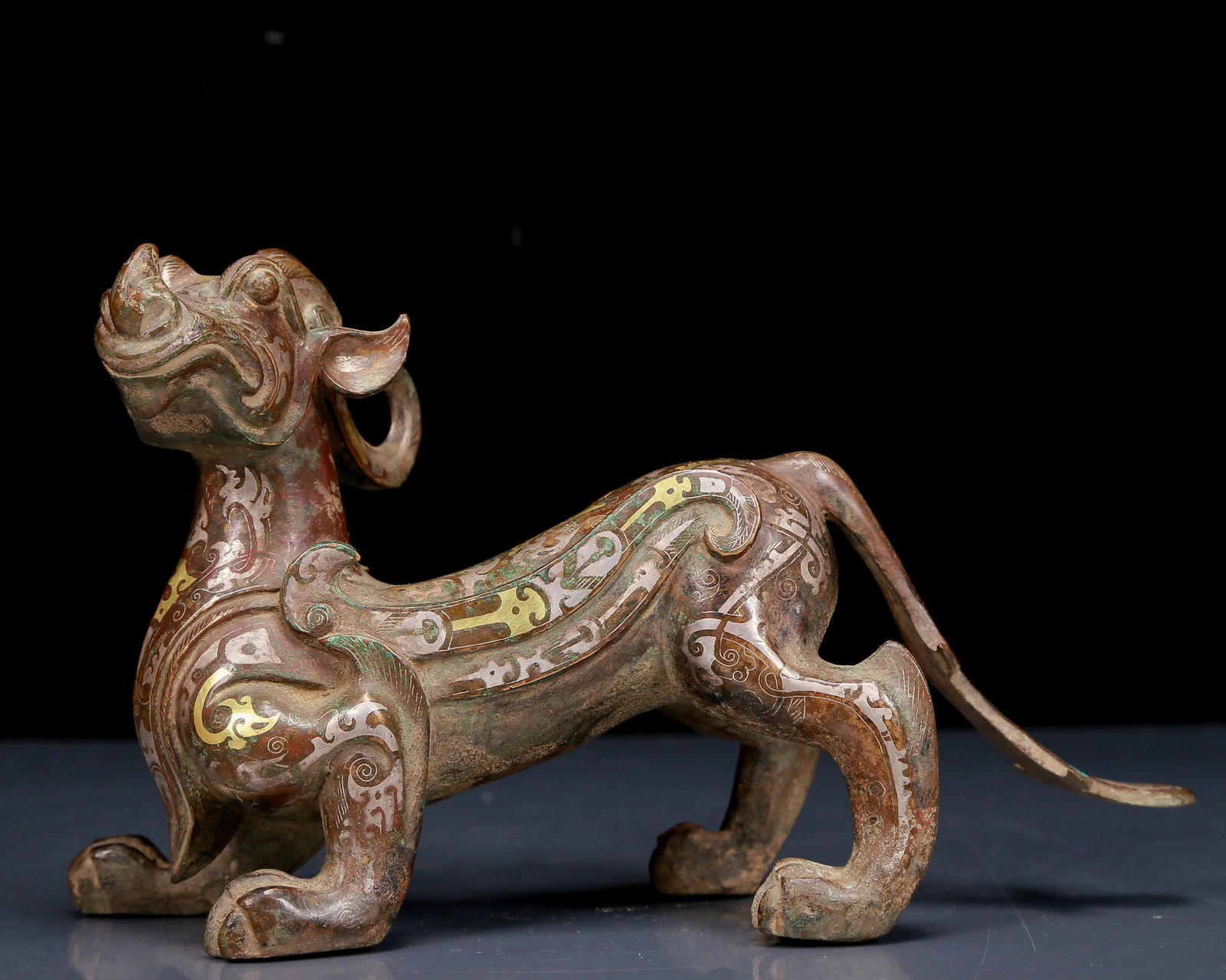 A Rare Bronze Inlaid Gold and Silver Auspicious Beast Ornament: A Rare Bronze Inlaid Gold and Silver Auspicious Beast Ornament,Ancient Time, China,Size:8.7inx3.5inx5.5in,Weight:1295g 铜错金银瑞兽摆件,远古