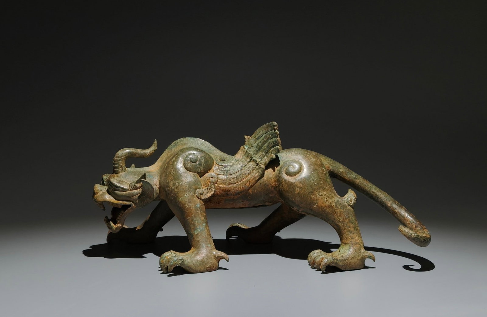 An Archaic Bronze Auspicious Beast Ornament: An Archaic Bronze Auspicious Beast Ornament,the Warring States period in China,Size:5.9inx14.2inx7.9in 青铜瑞兽摆件,中国战国时期